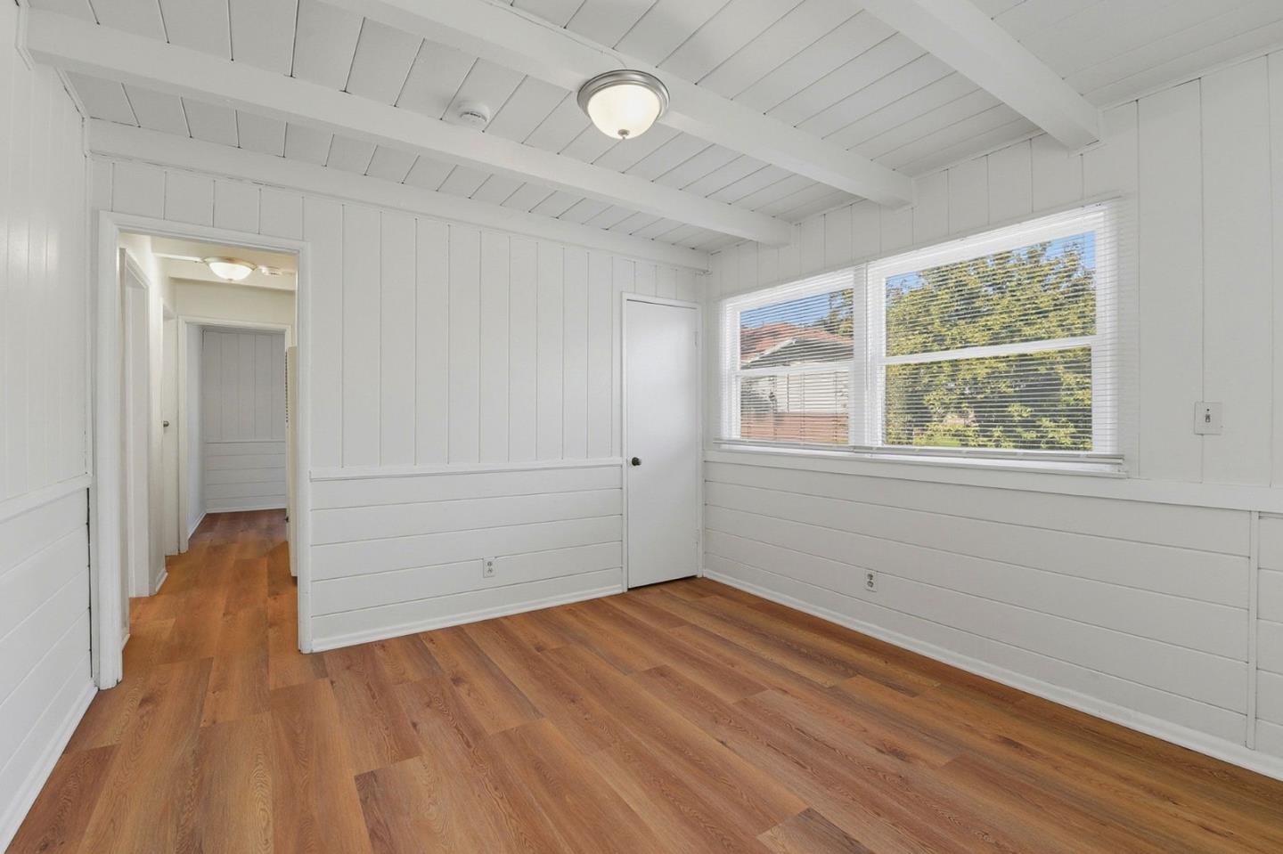 18601 Keswick Street, Unit B Reseda, CA 91335 - Photo 4 of 16 wooden floor in an empty room with a window
