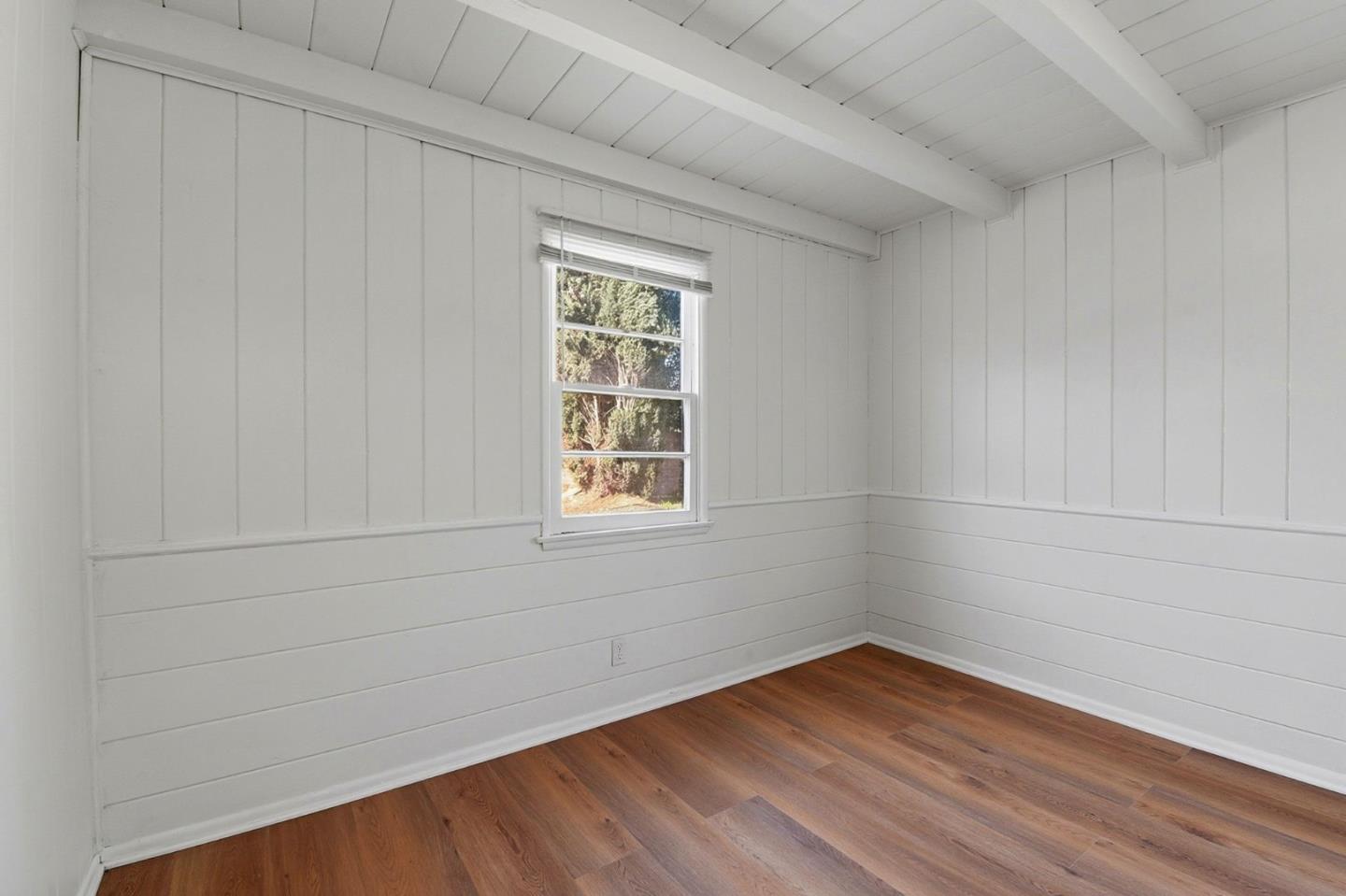 18601 Keswick Street, Unit B Reseda, CA 91335 - Photo 5 of 16 a view of an empty room with wooden floor and a window