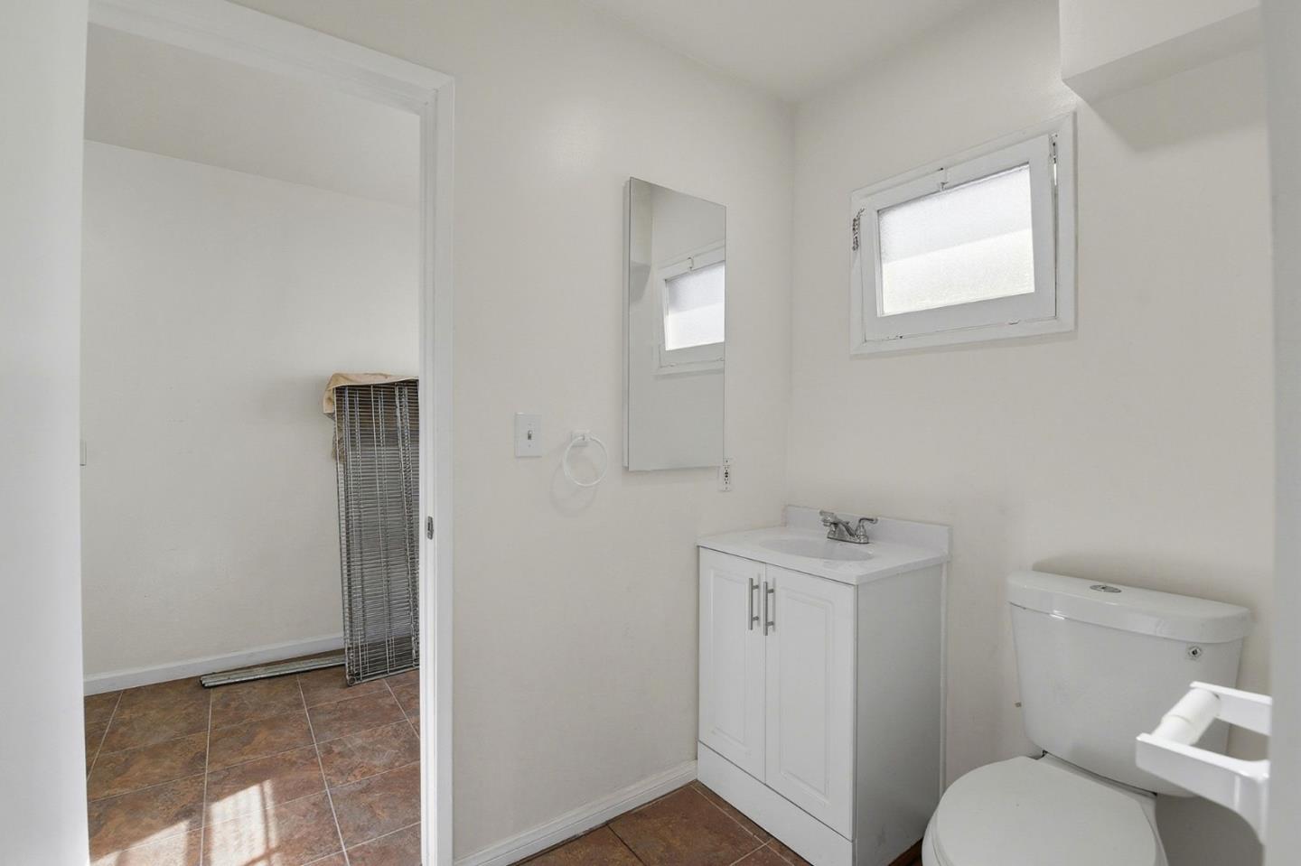 18601 Keswick Street, Unit B Reseda, CA 91335 - Photo 10 of 16 a bathroom with a sink toilet and window