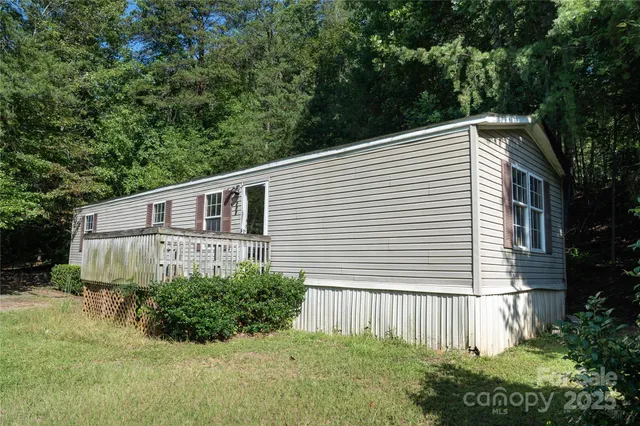 a side view of a house with a yard