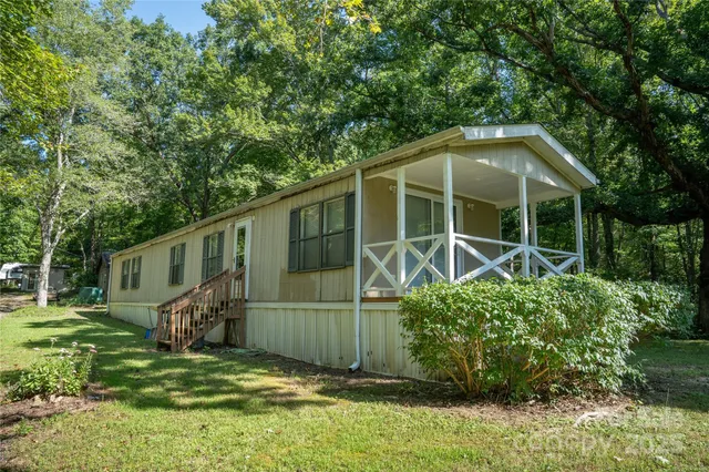 a view of a house with a yard and plants