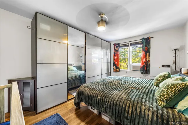 a bed sitting in a bedroom next to a window