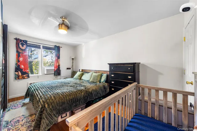 a bedroom with two beds and wooden floor