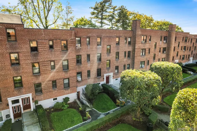 front view of a building with a garden