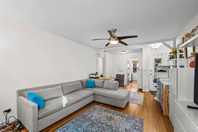 a living room with furniture kitchen view and a chandelier
