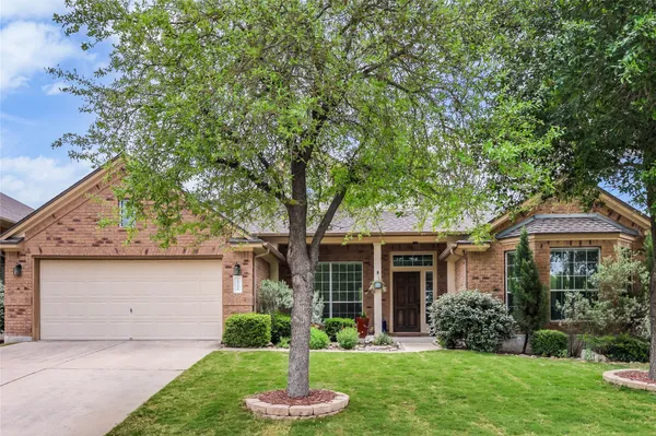 a bedroom with a bed and large windows