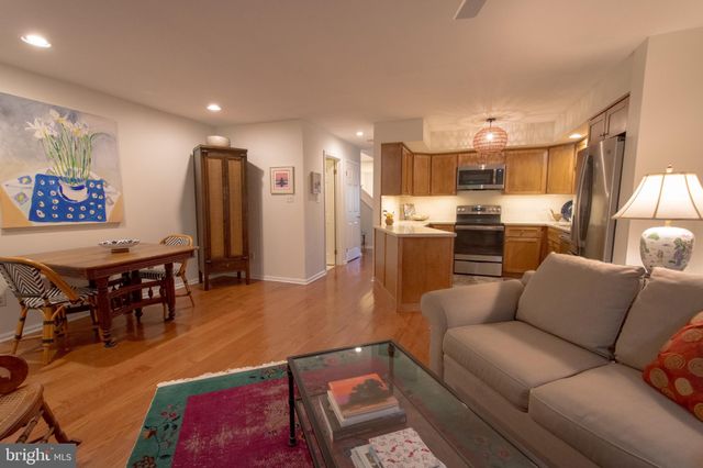 a living room with stainless steel appliances kitchen island granite countertop furniture and a view of kitchen