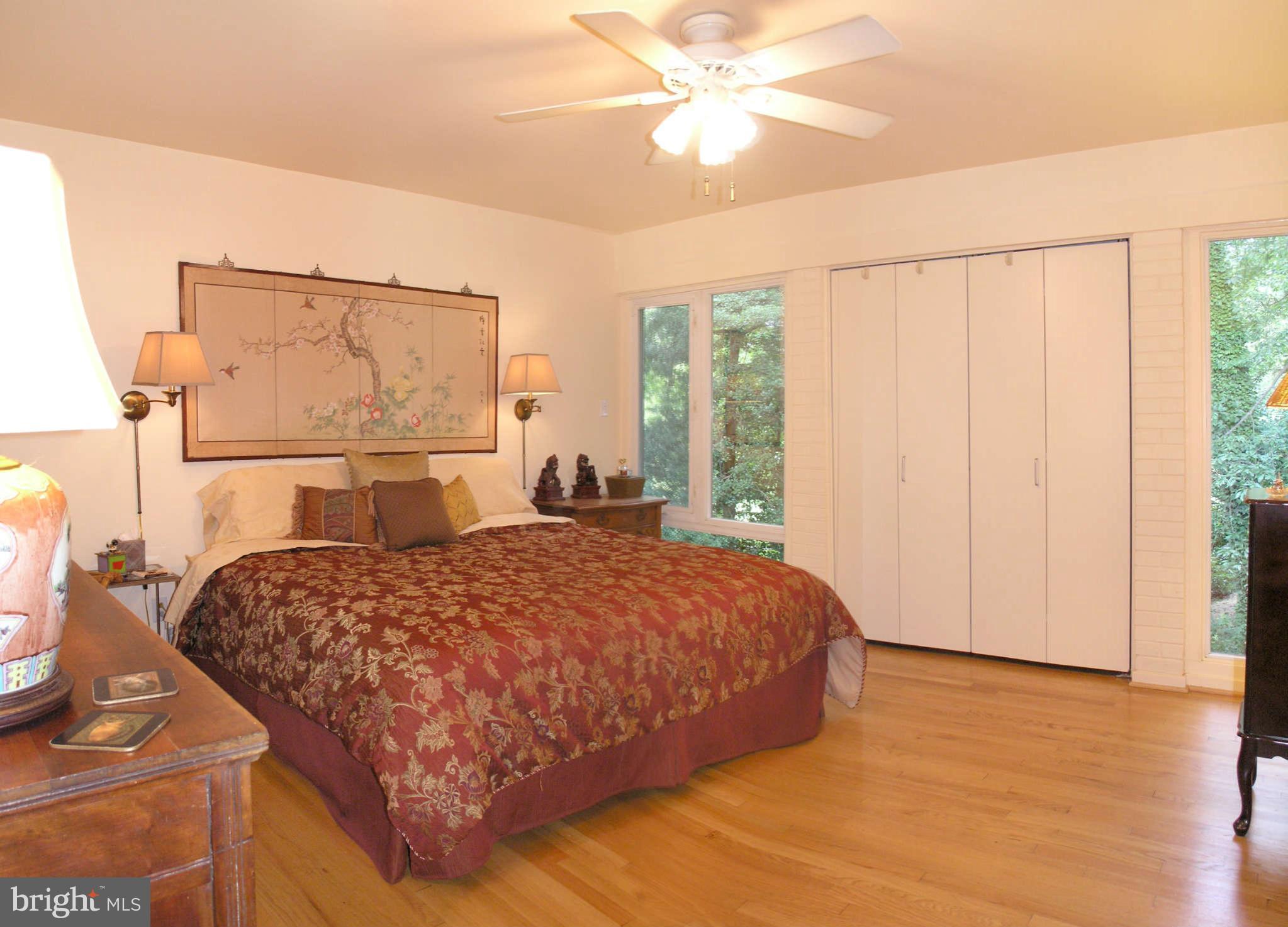 11431 Hook Road Reston, VA 20190 - Photo 18 of 30 a bedroom with a bed and a chandelier