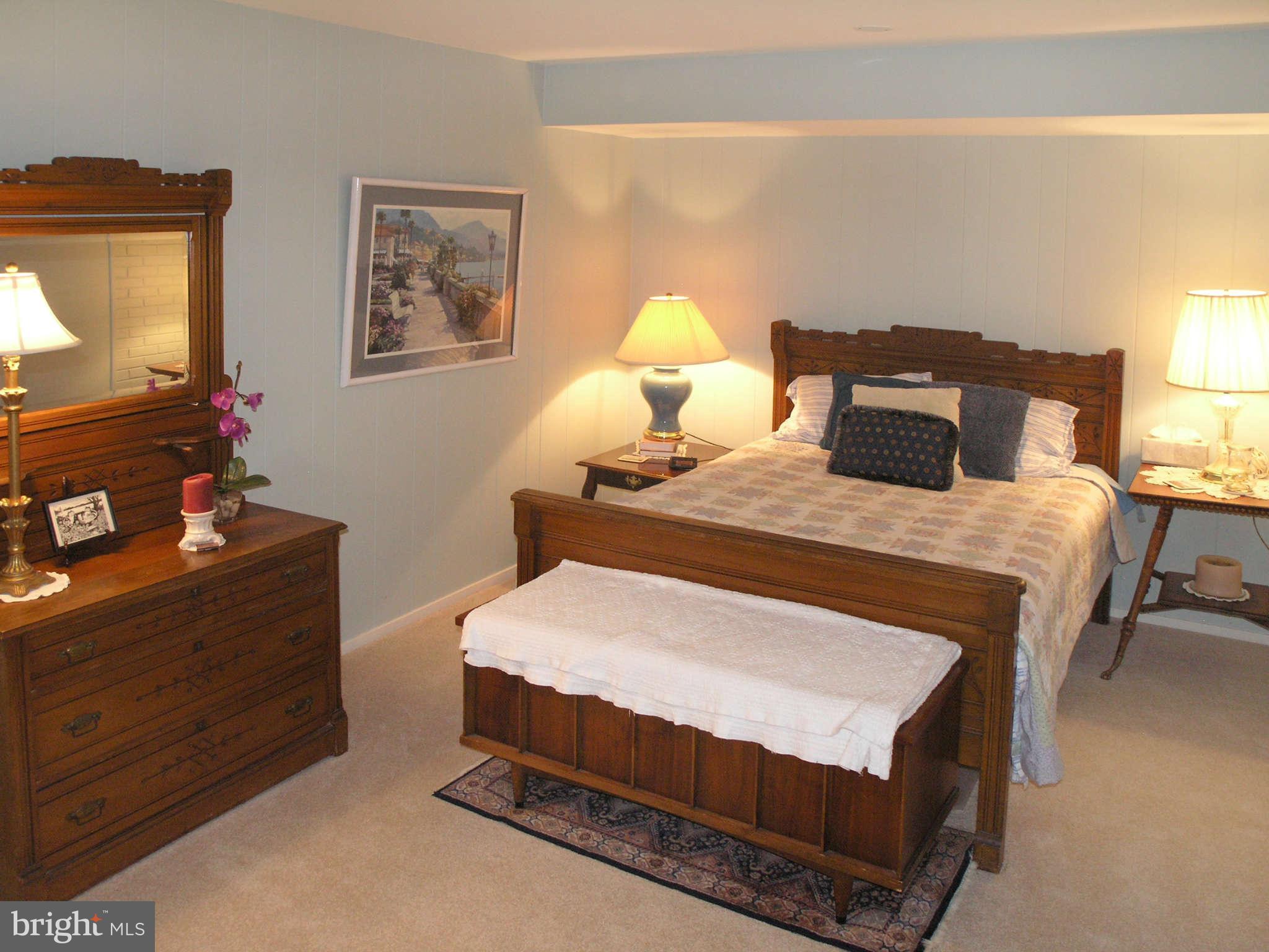 11431 Hook Road Reston, VA 20190 - Photo 25 of 30 a bedroom with a bed and wooden floor