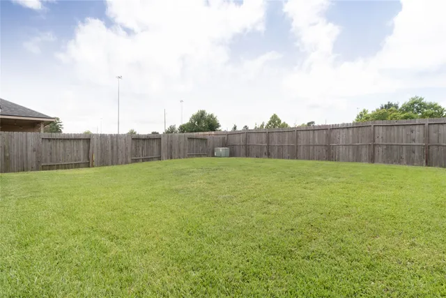 a view of a backyard with a basket ball court