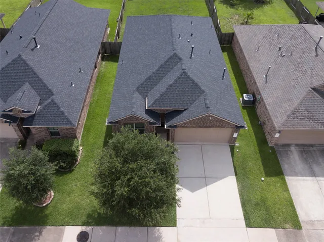 an aerial view of a house with a yard