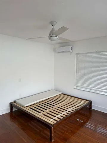 a view of a room with wooden floor and staircase