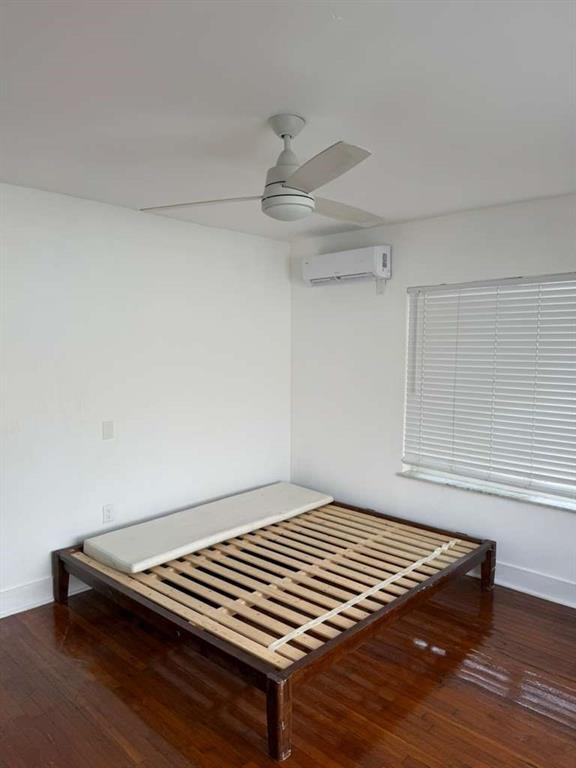 817 Tyler Street, Unit 8 Hollywood, FL 33019 - Photo 12 of 14 a view of a room with wooden floor and staircase
