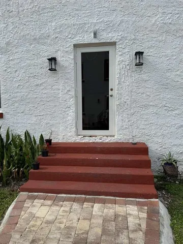 a front view of a house with stairs