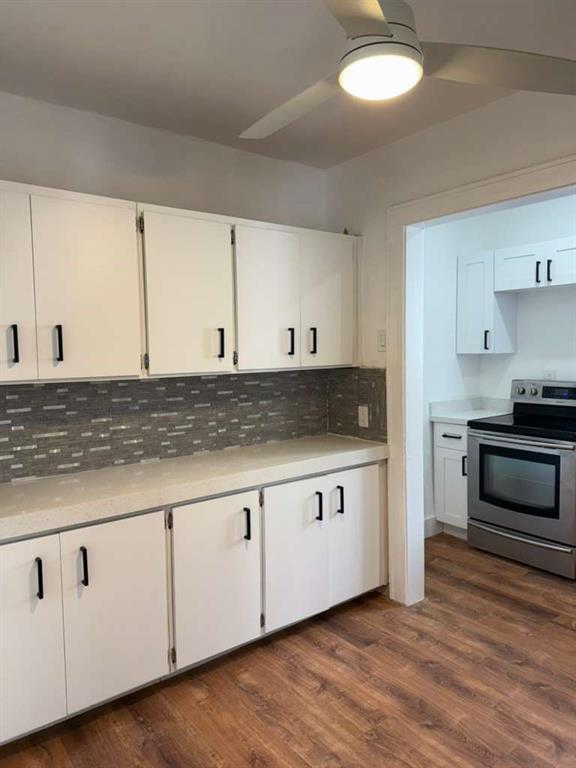 817 Tyler Street, Unit 8 Hollywood, FL 33019 - Photo 9 of 14 a kitchen with granite countertop white cabinets and appliances