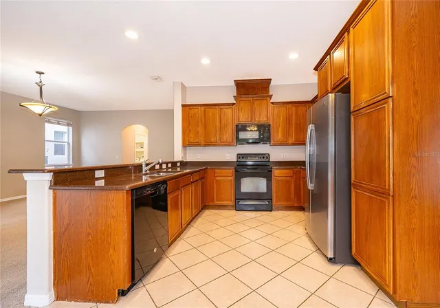 a kitchen with stainless steel appliances a refrigerator and a stove