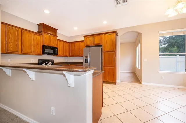a kitchen with stainless steel appliances a refrigerator sink and microwave
