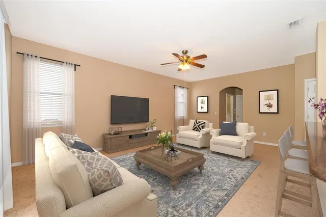 a living room with furniture and a flat screen tv