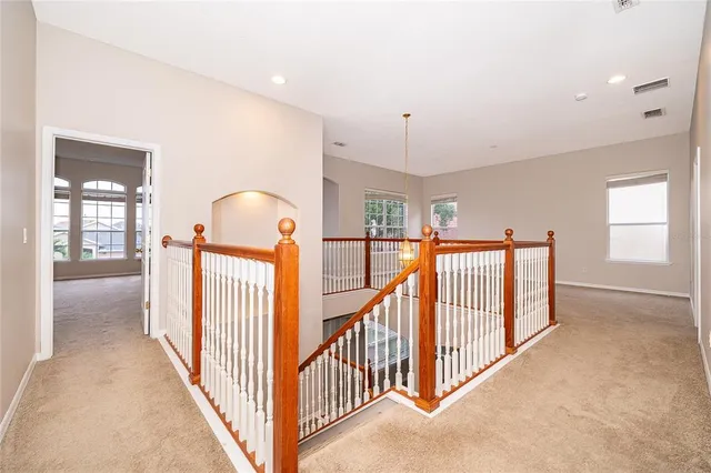 a view of a hallway with window and stairs