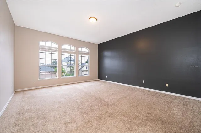 an empty room with windows and city view