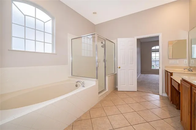 a spacious bathroom with a tub shower and sink