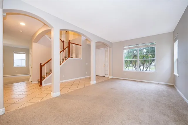 an empty room with windows and entrance