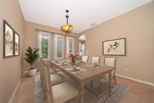 a view of a dining room with furniture and chandelier