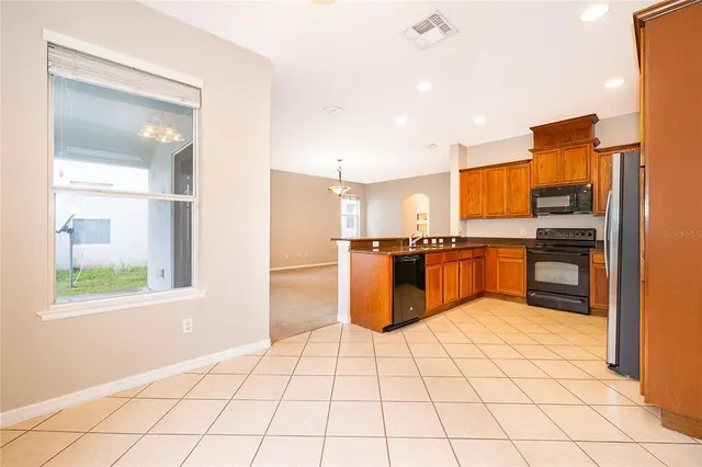 a kitchen with stainless steel appliances a refrigerator and window
