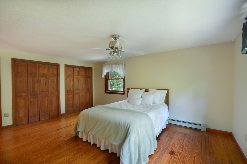 41 Braeside Road Falmouth, MA 02540 - Photo 17 of 24 a bedroom with a bed and wooden floor