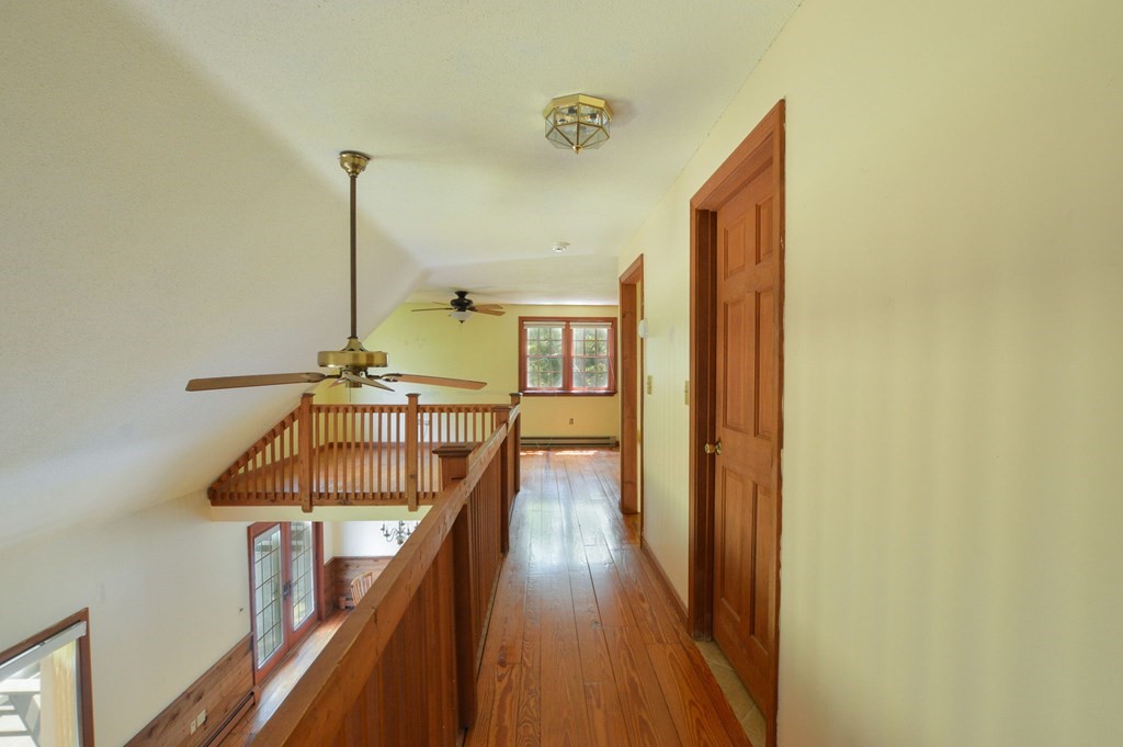 41 Braeside Road Falmouth, MA 02540 - Photo 18 of 24 a view of hallway with wooden floor and stairs