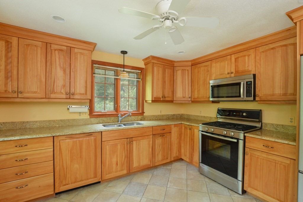 41 Braeside Road Falmouth, MA 02540 - Photo 6 of 24 a kitchen with stainless steel appliances granite countertop a stove sink microwave and cabinets