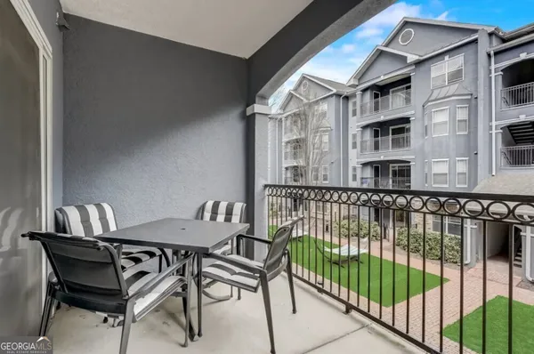 a view of a chairs and a table in the balcony