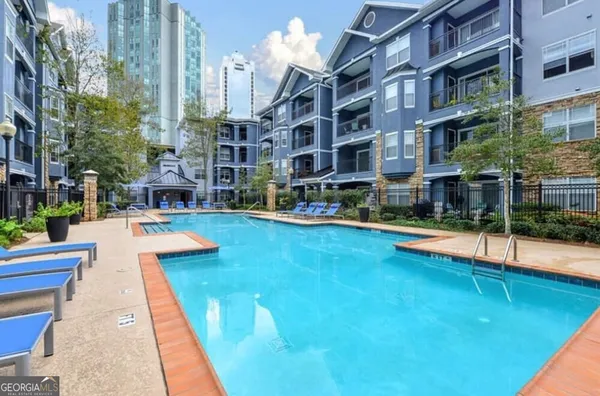 a swimming pool with outdoor seating and yard