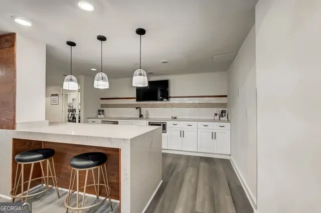 a kitchen with a stove and white cabinets