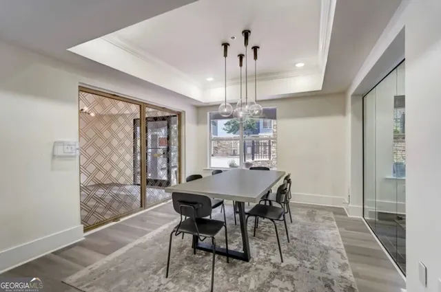 a view of a dining room with furniture wooden floor and chandelier