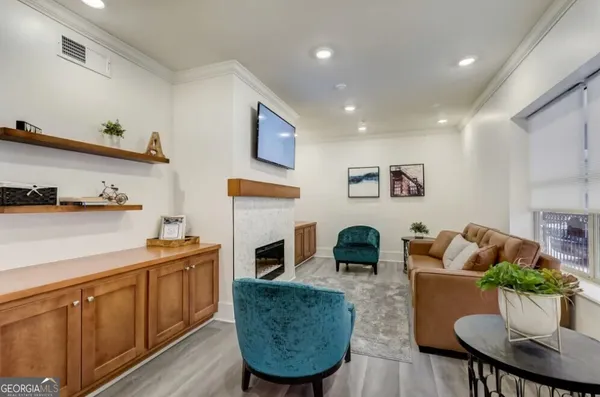 a living room with furniture kitchen view and a fireplace