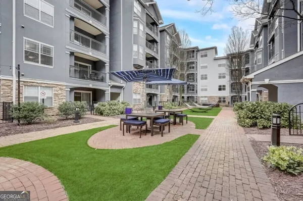 a view of a patio with couches and a table and chairs