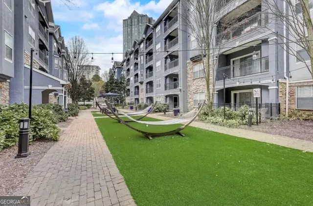 a view of a patio with couches table and chairs and potted plants