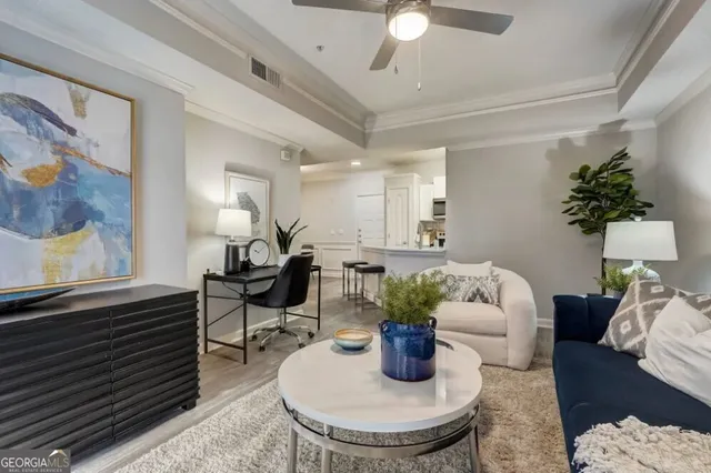 a living room with furniture and flowers
