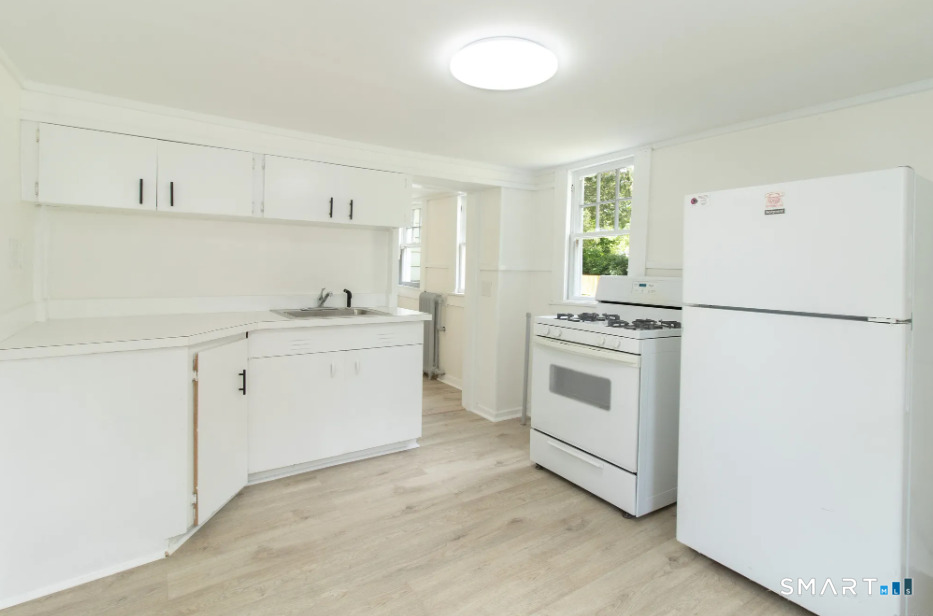30 Grove Street, Unit B Branford, CT 06405 - Photo 2 of 7 a kitchen with white cabinets and white appliances
