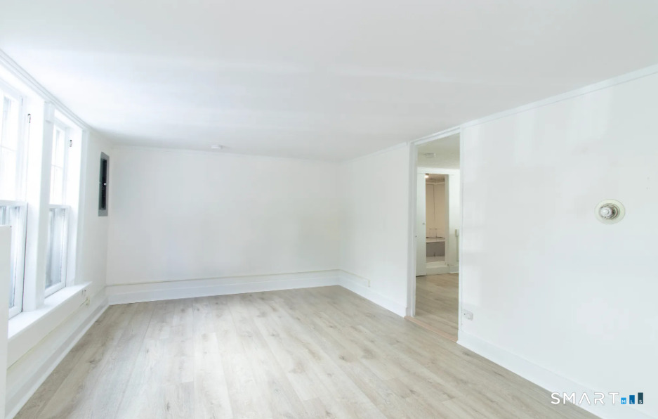 30 Grove Street, Unit B Branford, CT 06405 - Photo 4 of 7 an empty room with wooden floor and windows