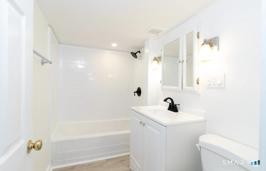 30 Grove Street, Unit B Branford, CT 06405 - Photo 7 of 7 a bathroom with a sink a toilet and shower