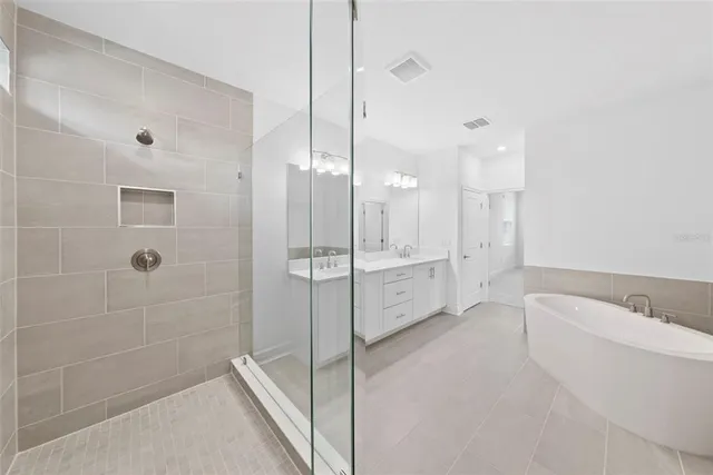 a spacious bathroom with a granite countertop sink mirror and shower