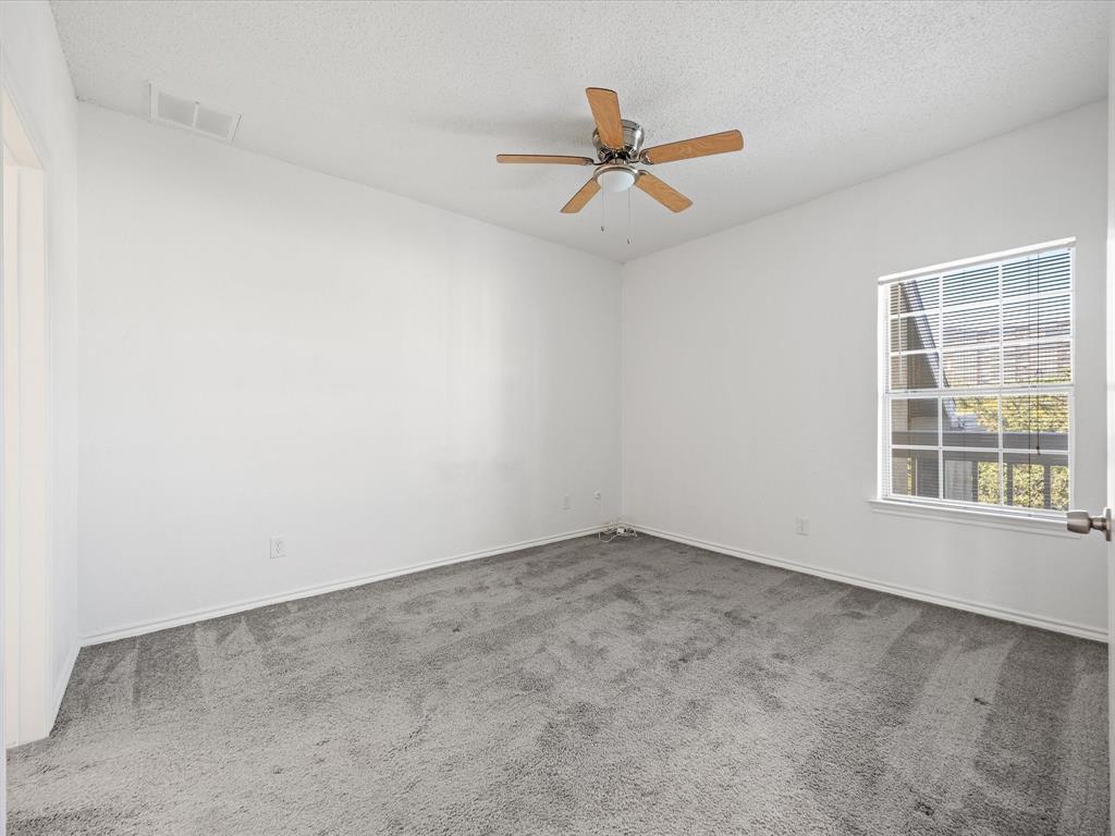 5310 Keller Springs Road, Unit 332 Dallas, TX 75248 - Photo 8 of 39 Carpeted spare room with a textured ceiling and a ceiling fan