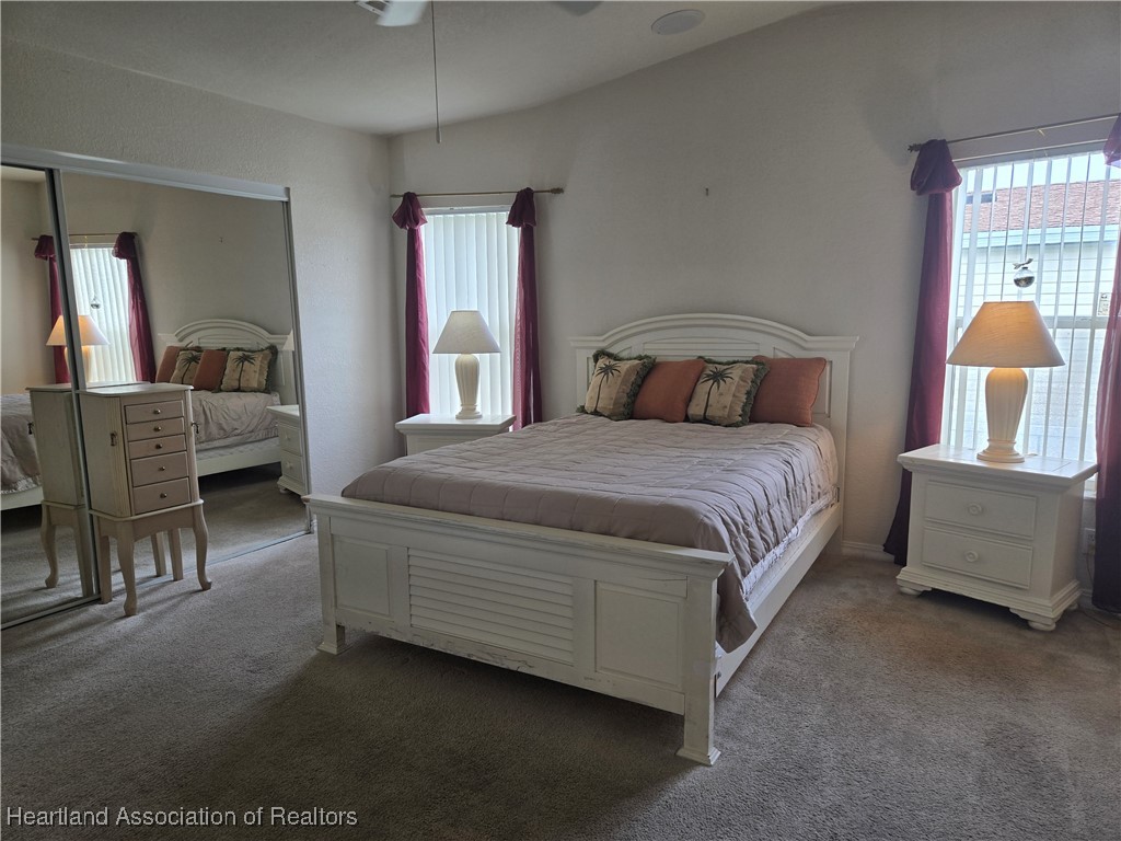 3312 Beartooth Pass Sebring, FL 33872 - Photo 21 of 39 a bedroom with a bed and a couch