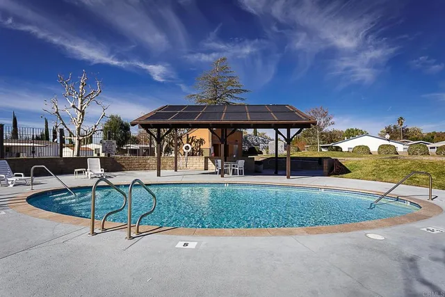 a view of a swimming pool with an outdoor seating