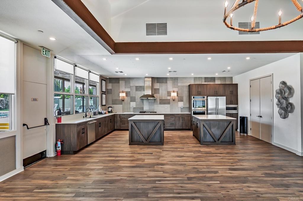 21423 Bramble Way Saugus, CA 91350 - Photo 22 of 29 a kitchen with stainless steel appliances kitchen island granite countertop a stove and a view of living room