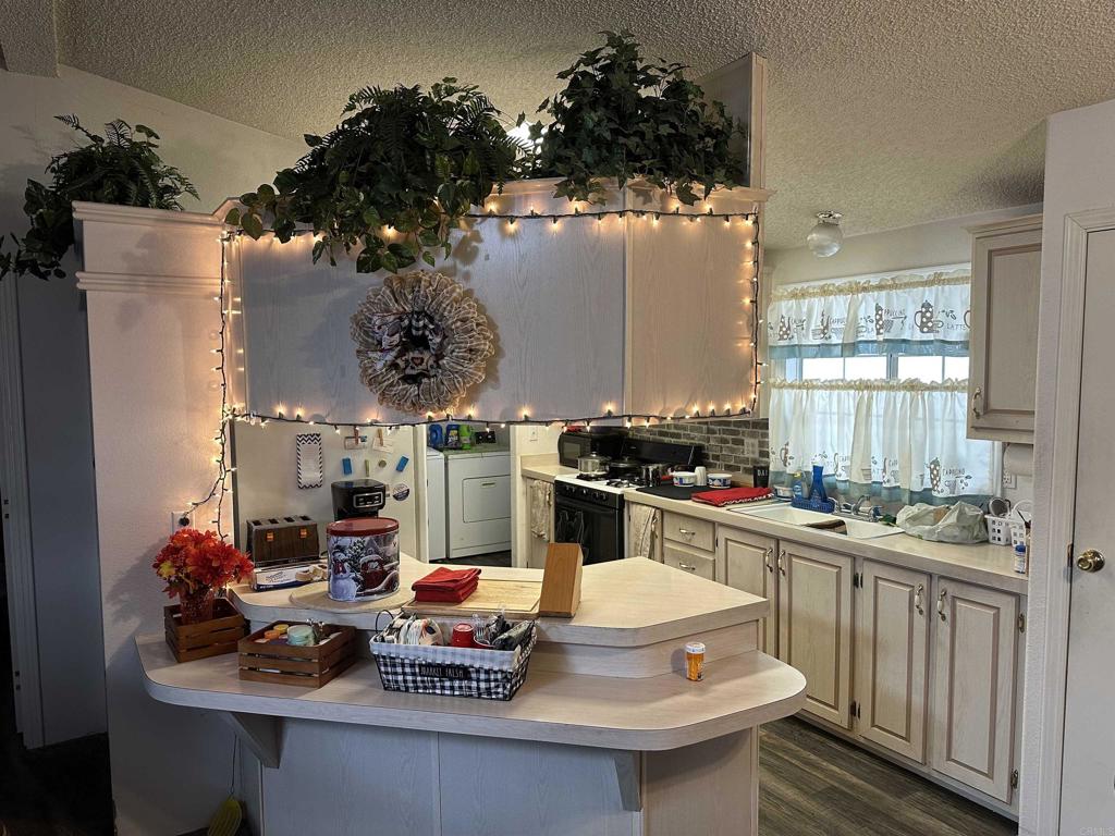 21423 Bramble Way Saugus, CA 91350 - Photo 8 of 29 a kitchen with a sink appliances and cabinets