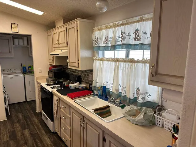 a kitchen with a stove a sink and a refrigerator
