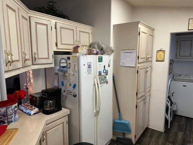 a view of a kitchen with refrigerator and washer